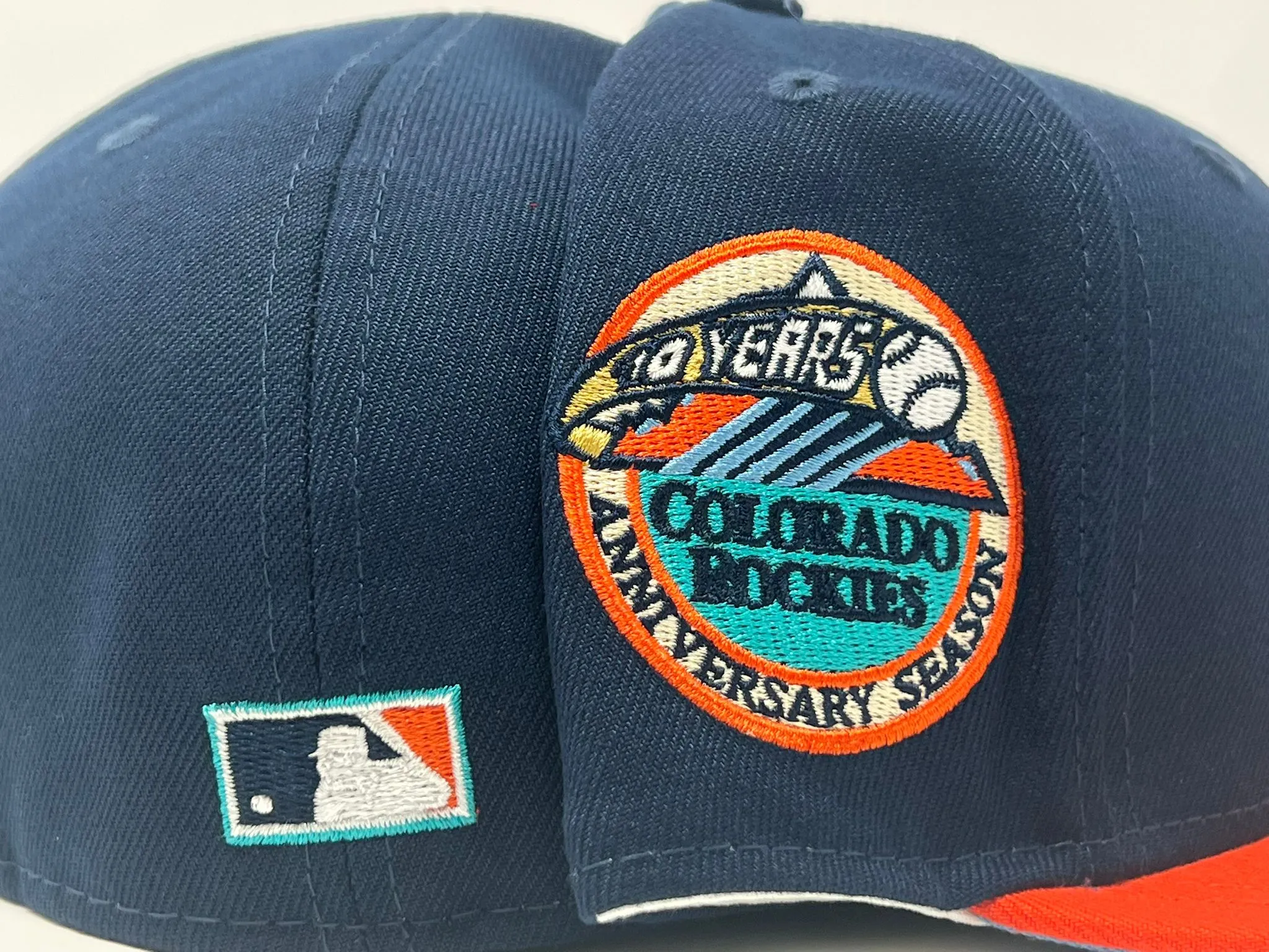 COLORADO ROCKIES 10TH ANNIVERSARY LIGHT NAVY ORANGE VISOR ICY BRIM NEW ERA FITTED HAT